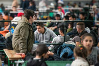 Refugees wait at a registration facility for asylum seekers of the German Federal Police (EPA Photo)
