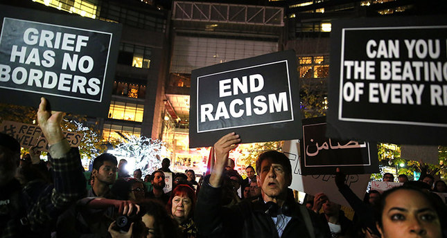 People listen to speakers at a demonstration against racism and conservative presidential candidate Trumps recent remarks concerning Muslims on Dec 10, 2015 in New York City. (AFP Photo)