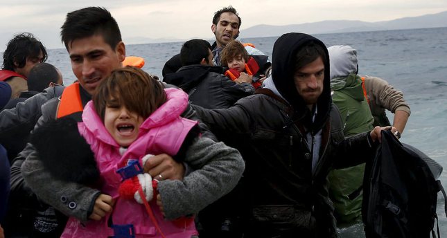 Refugees and migrants arrive on an inflattable raft at the Greek island of Lesbos.