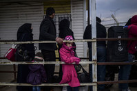 Syrian refugees wait in front of the Öncüpınar crossing gate to go back to Syria, near the town of Kilis, in south-central Turkey, on Feb 11, 2016 (AFP)