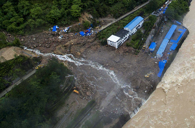 Several bodies have been found but dozens people were still missing Monday following a landslide at the site of a hydropower project after days of heavy rain in southern China. (AP Photo)