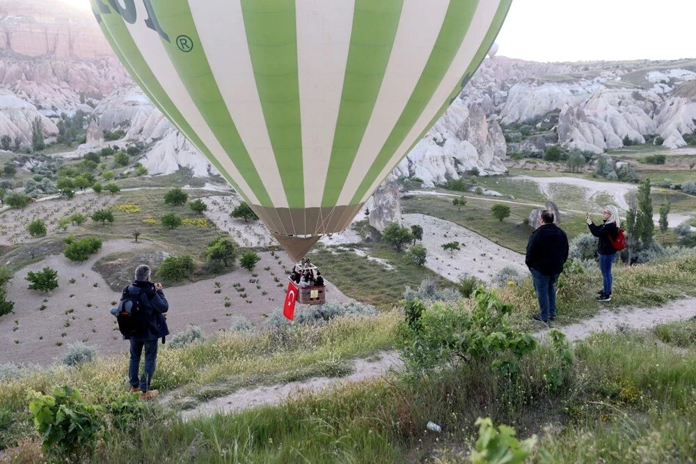 Cappadocia hot air balloons fly with Turkish flags for Victory Day